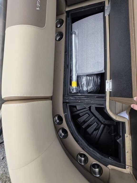 Slide: The Image of 2025 Veranda VR22RC XL Tri-Toon storage compartment with cup holders and seating. - 35