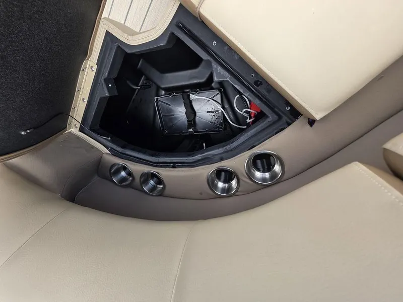 Slide: The Image of Interior view of 2025 Veranda VR22RC XL Tri-Toon, showcasing storage compartment and cup holders. - 36