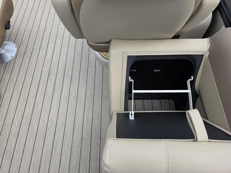 Slide: The Image of 2025 Veranda VR22RC XL Tri-Toon interior with open storage compartment and beige seating. - 38