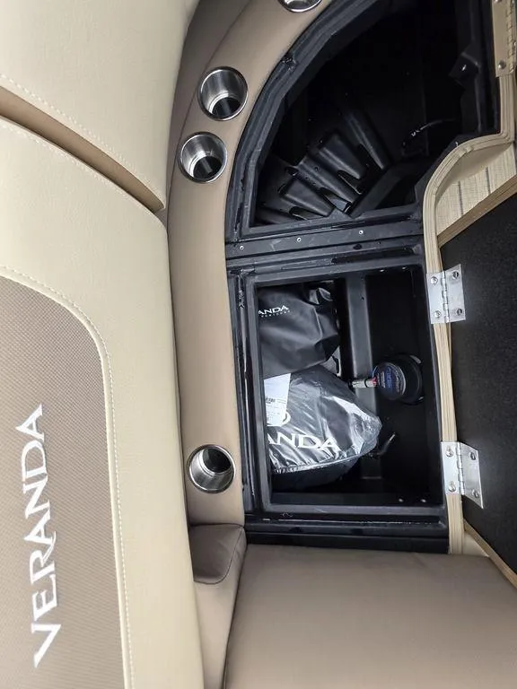 Slide: The Image of 2025 Veranda VR22RC XL Tri-Toon interior storage compartment with cup holders and branded seating. - 40
