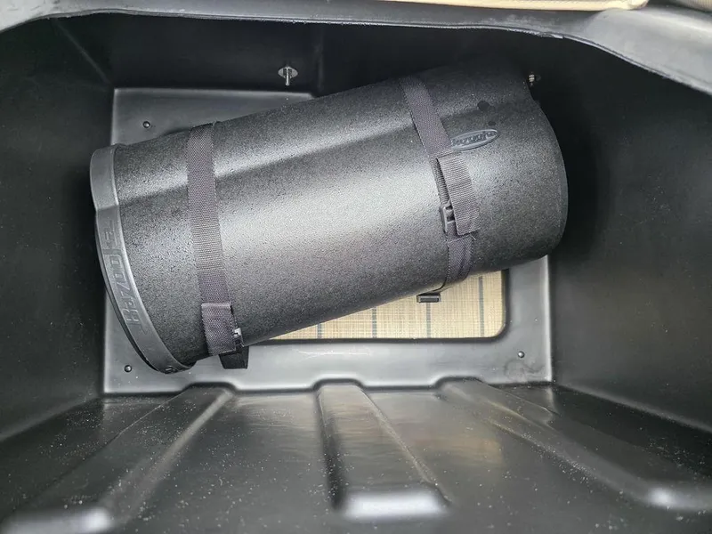 Slide: The Image of Storage compartment in 2025 Veranda VR22RC XL Tri-Toon with secured black container. - 44