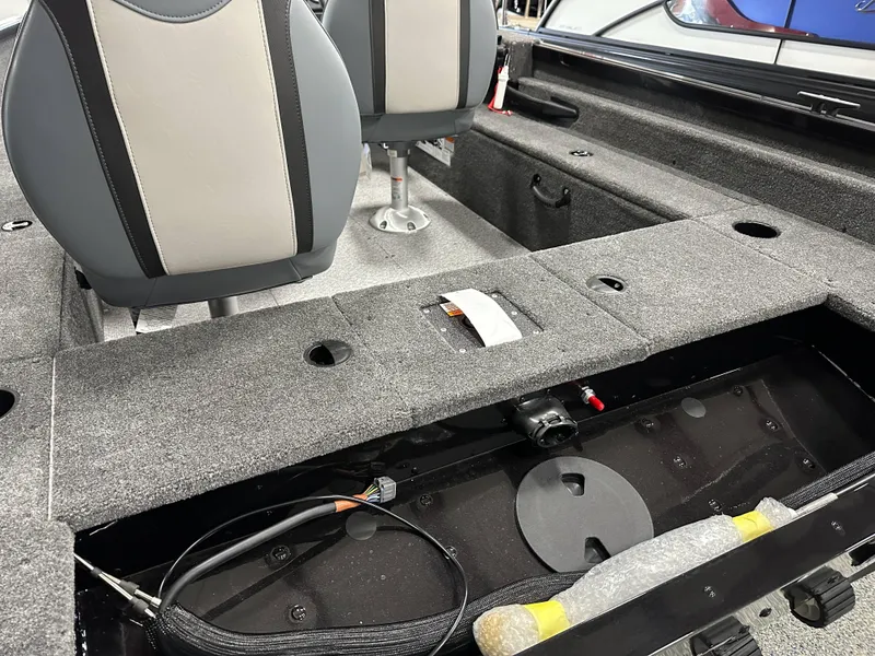 Slide: The Image of 2024 Alumacraft Classic 165 SC boat interior with seating and storage compartments. - 12