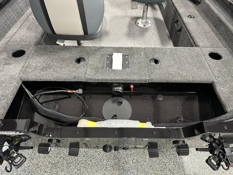 Slide: The Image of 2024 Alumacraft Classic 165 SC boat interior with storage compartment and seating. - 17