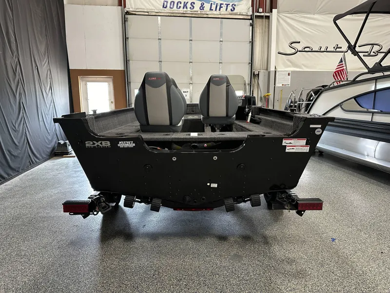 Slide: The Image of 2024 Alumacraft Classic 165 SC boat in showroom, rear view with dual seats. - 18