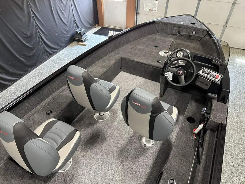 Slide: The Image of 2024 Alumacraft Classic 165 SC boat interior with dual seats and steering console. - 3