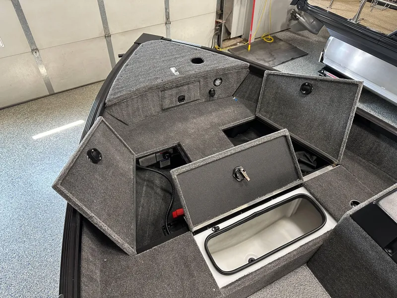 Slide: The Image of 2024 Alumacraft Classic 165 SC boat interior with open storage compartments. - 6