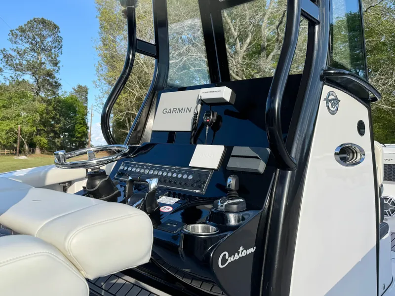 Slide: The Image of 2024 Tidewater 292 CC Adventure boat console with Garmin navigation system and custom seating. - 12