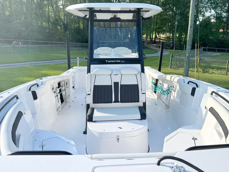 Slide: The Image of 2024 Tidewater 292 CC Adventure boat with spacious deck and modern seating. - 14