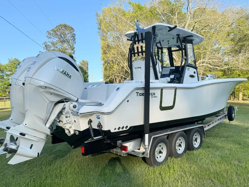 Slide: The Image of 2024 Tidewater 292 CC Adventure boat on trailer, featuring Yamaha outboard engines. - 6
