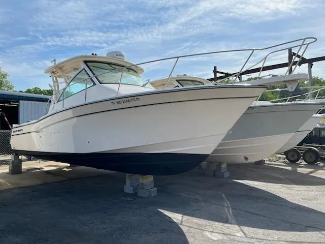 Slide: The Image of 2019 Grady-White Express 330 boat on display in a marina setting. - 0