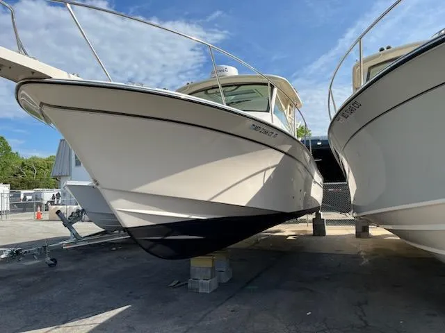 Slide: The Image of 2019 Grady-White Express 330 boat on display, docked outdoors under a clear sky. - 1