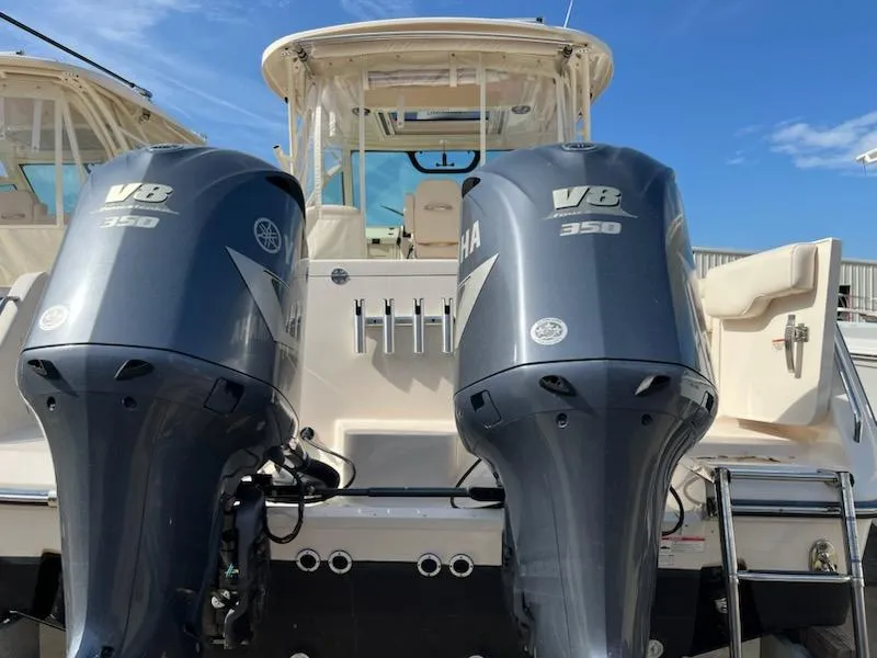 Slide: The Image of 2019 Grady-White Express 330 with twin Yamaha V8 350 engines, rear view. - 2