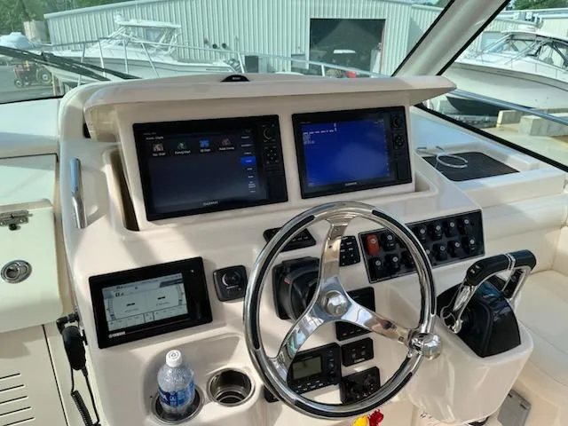Slide: The Image of 2019 Grady-White Express 330 helm with dual displays and steering wheel. - 3