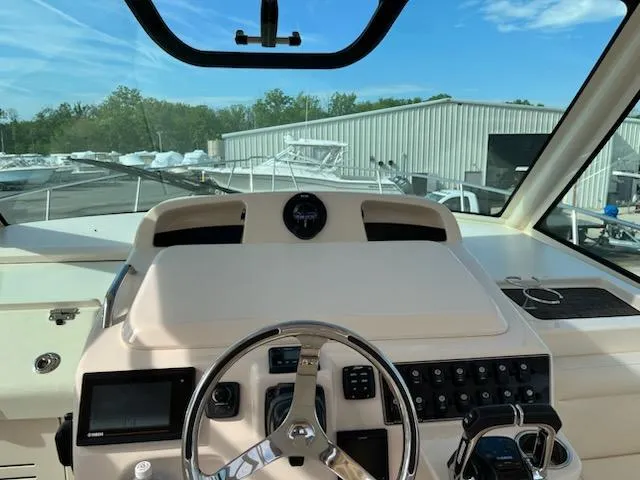 Slide: The Image of Helm of 2019 Grady-White Express 330 boat with steering wheel and control panel. - 4