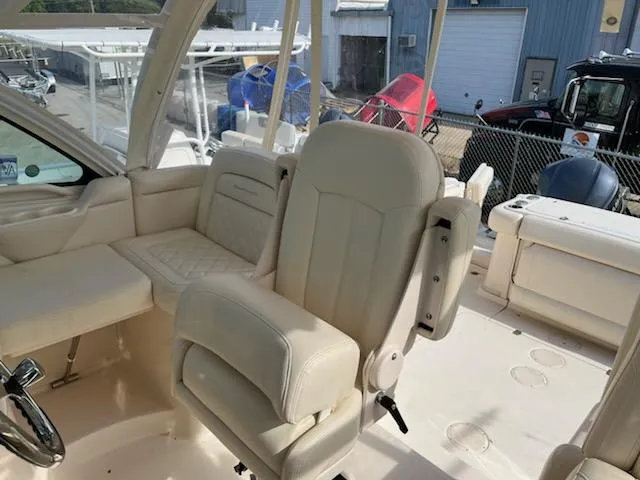 Slide: The Image of 2019 Grady-White Express 330 boat interior with plush seating and helm station. - 7