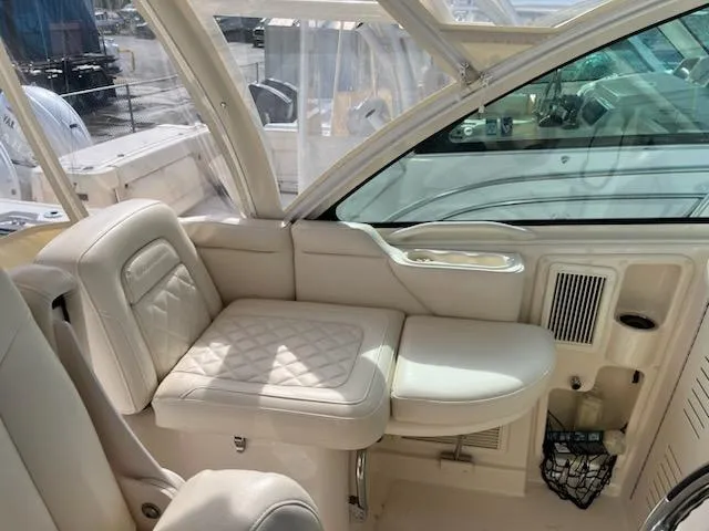 Slide: The Image of 2019 Grady-White Express 330 interior with beige seating and window view. - 8