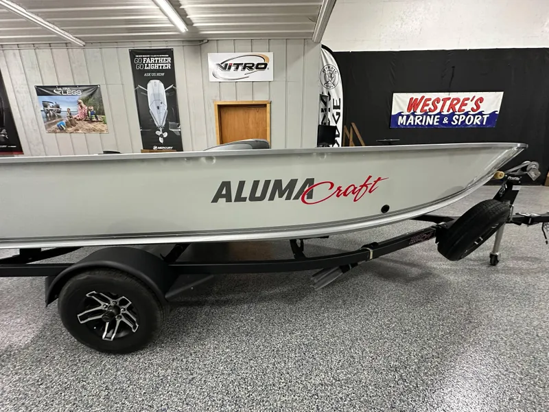 Slide: The Image of 2024 Alumacraft Classic 165 Tiller boat on display in showroom. - 1