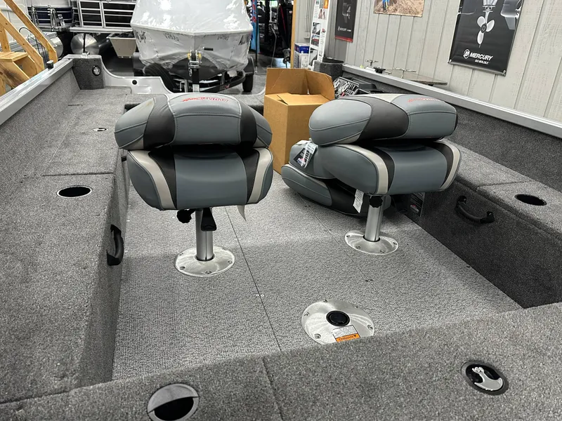 Slide: The Image of 2024 Alumacraft Classic 165 Tiller boat interior with two gray seats. - 11