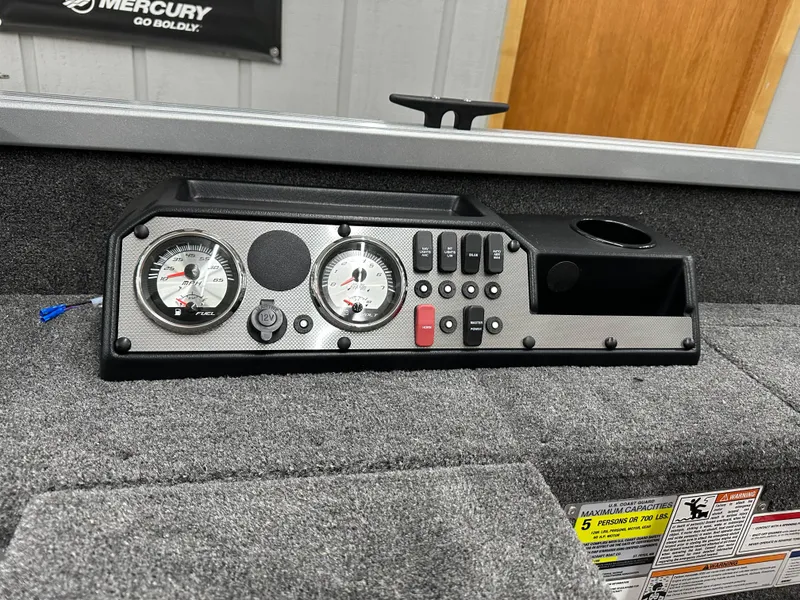 Slide: The Image of 2024 Alumacraft Classic 165 Tiller boat interior with control panel and gauges. - 13