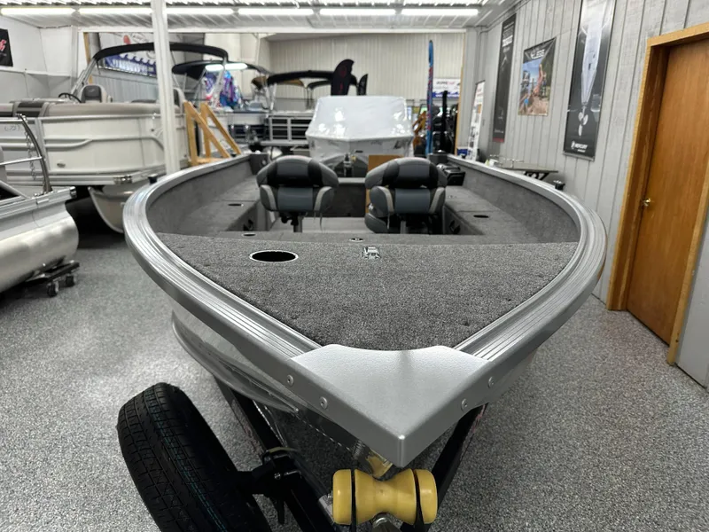 Slide: The Image of 2024 Alumacraft Classic 165 Tiller boat in showroom, featuring spacious interior and modern design. - 4