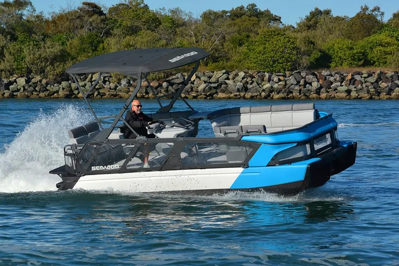 Slide: The Image of 2024 Sea-Doo Switch® Cruise 21 - 170 hp pontoon boat cruising on water. - 11