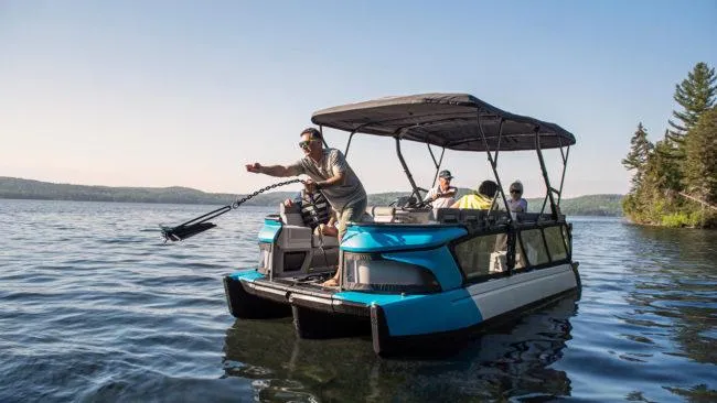 Slide: The Image of 2024 Sea-Doo Switch® Cruise 21 on a serene lake, with passengers enjoying the ride. - 6