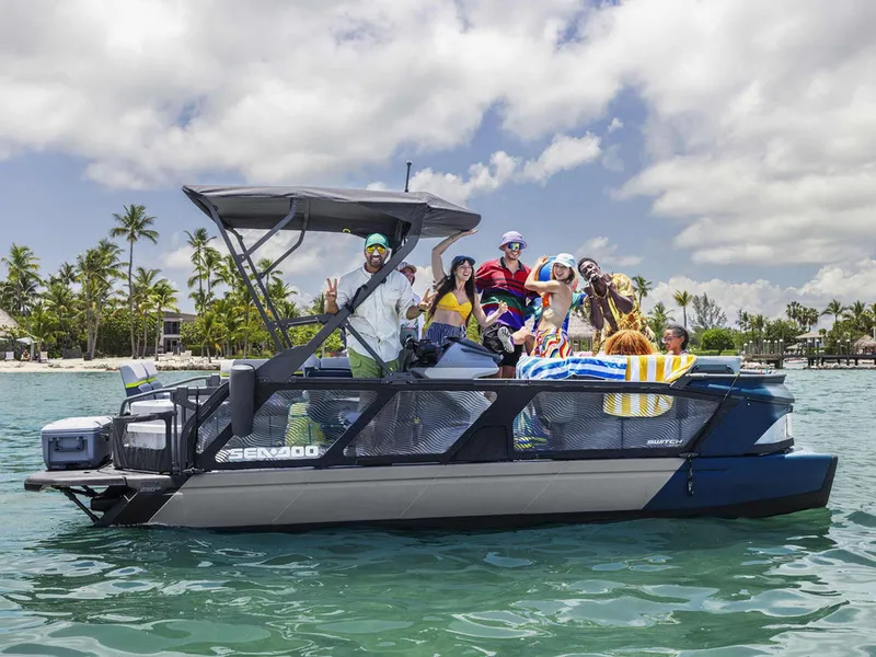 Slide: The Image of 2024 Sea-Doo Switch® Cruise 21 with passengers enjoying a sunny day on the water. - 8