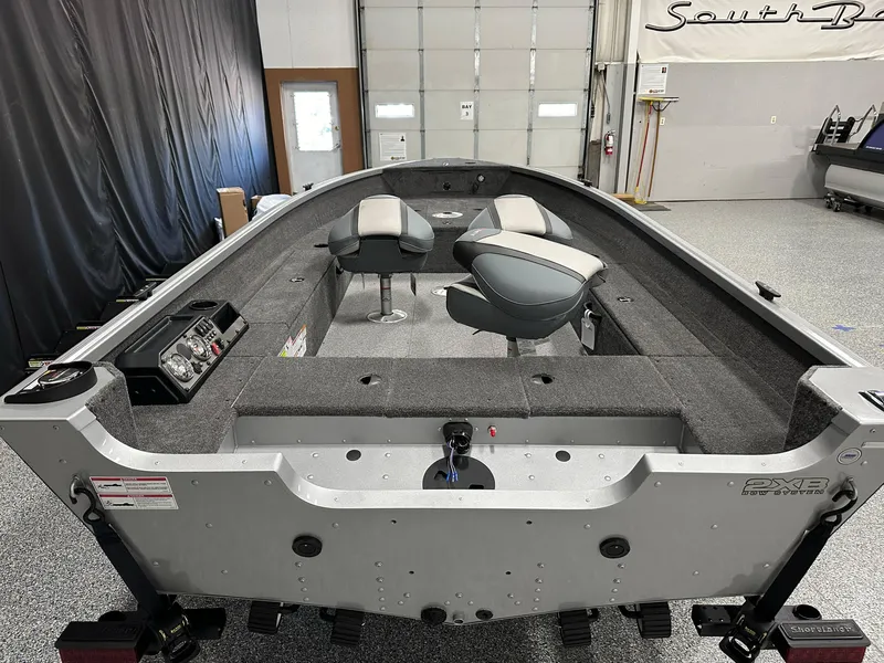 Slide: The Image of 2024 Alumacraft Classic 165 Tiller boat interior with seating and control panel. - 11