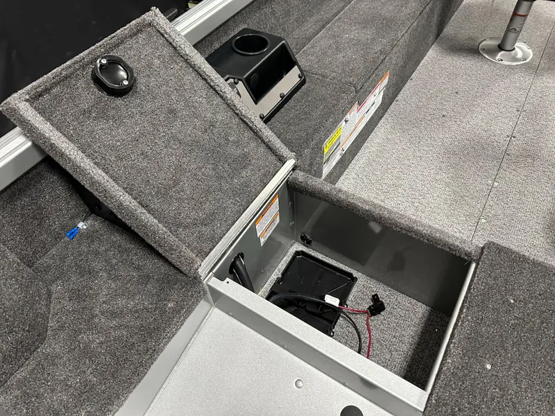 Slide: The Image of 2024 Alumacraft Classic 165 Tiller boat interior with open storage compartment. - 13