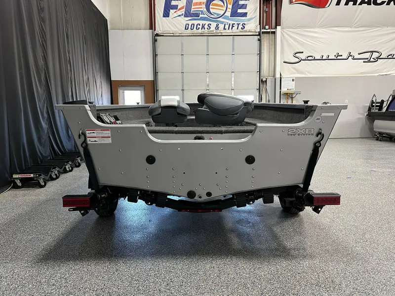 Slide: The Image of 2024 Alumacraft Classic 165 Tiller boat in showroom, rear view, gray interior. - 15