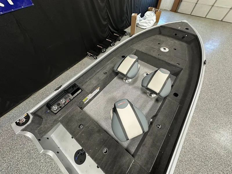 Slide: The Image of 2024 Alumacraft Classic 165 Tiller boat interior with two seats and control panel. - 16