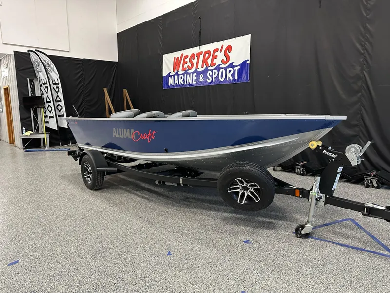 Slide: The Image of 2024 Alumacraft Classic 165 Tiller boat on display at Westre's Marine & Sport. - 2
