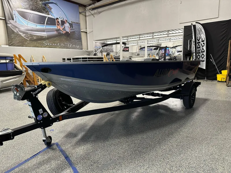 Slide: The Image of 2024 Alumacraft Classic 165 Tiller boat on display in showroom. - 3