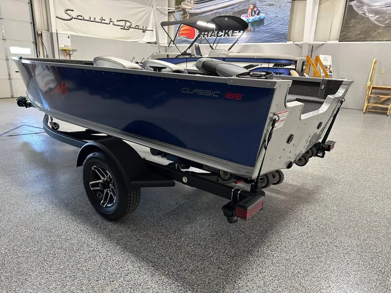 Slide: The Image of 2024 Alumacraft Classic 165 Tiller boat on trailer in showroom. - 4