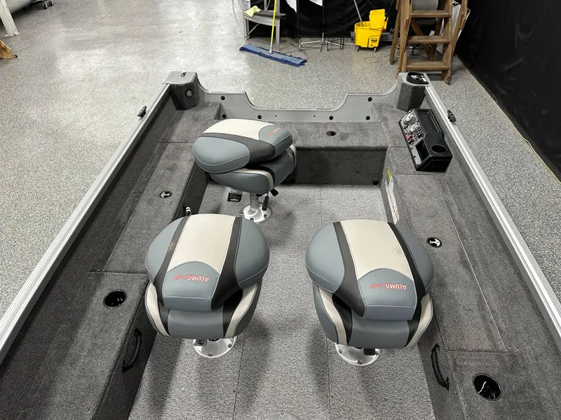 Slide: The Image of 2024 Alumacraft Classic 165 Tiller boat interior with two cushioned seats. - 9