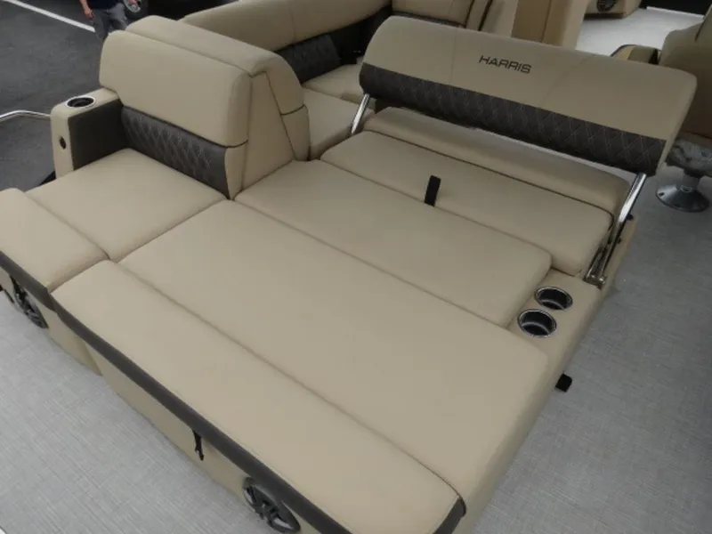 Slide: The Image of 2023 Harris Sunliner 230 boat interior with beige seating and cup holders. - 11