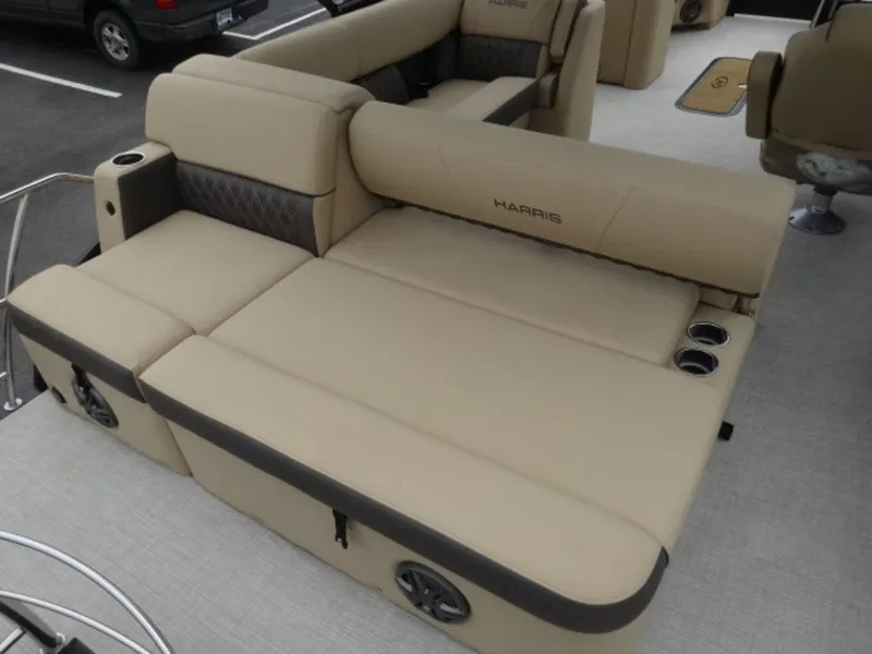 Slide: The Image of 2023 Harris Sunliner 230 boat interior with beige seating and cup holders. - 12