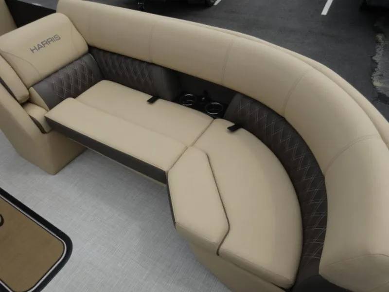 Slide: The Image of 2023 Harris Sunliner 230 boat interior with beige seating and cup holders. - 15