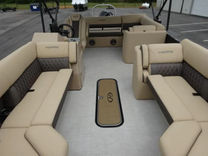 Slide: The Image of 2023 Harris Sunliner 230 pontoon boat interior with beige seating and spacious layout. - 18