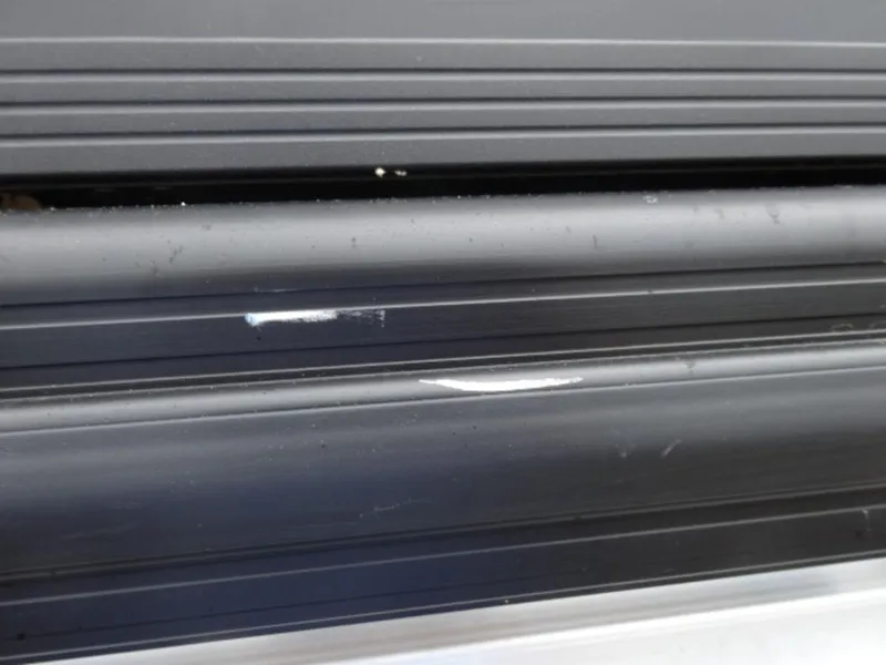 Slide: The Image of Close-up of 2023 Harris Sunliner 230 exterior detailing with minor scratches. - 2