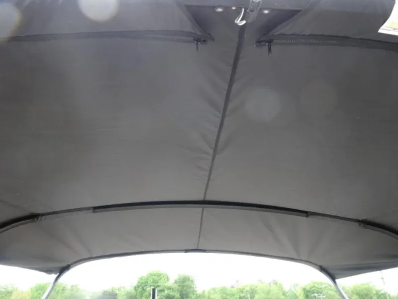 Slide: The Image of 2023 Harris Sunliner 230 boat canopy, black fabric, outdoor setting. - 3