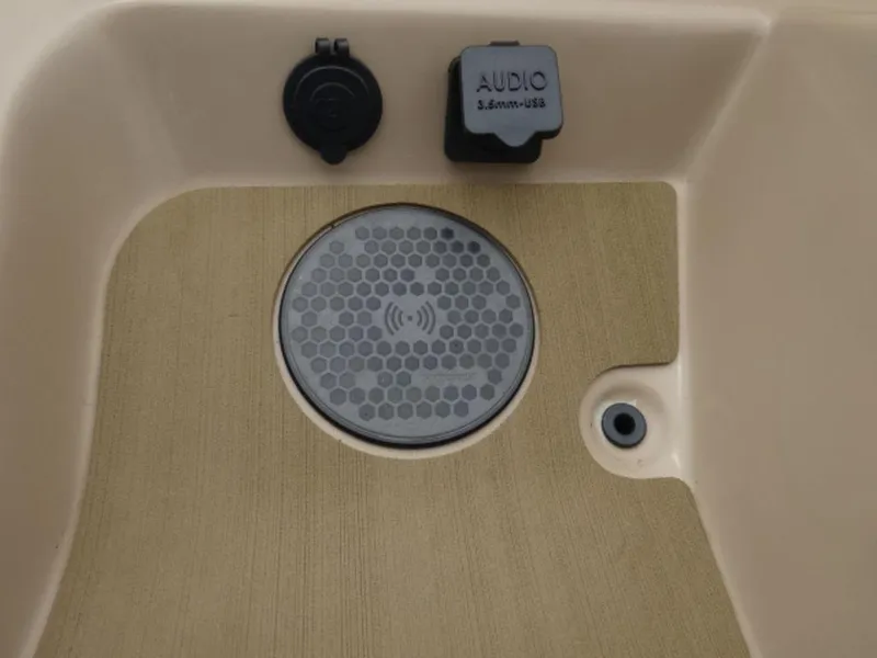 Slide: The Image of 2023 Harris Sunliner 230 audio panel with USB and 12V socket on beige surface. - 5