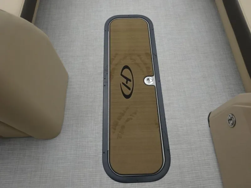 Slide: The Image of 2023 Harris Sunliner 230 boat interior with wood panel and logo. - 6