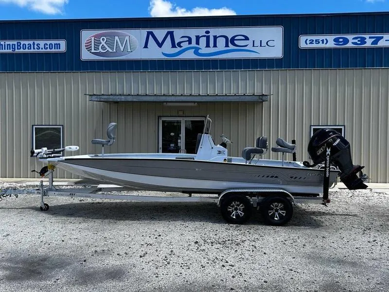 Slide: The Image of 2025 Xpress H22B boat at I&M Marine LLC dealership, featuring dual-axle trailer. - 0
