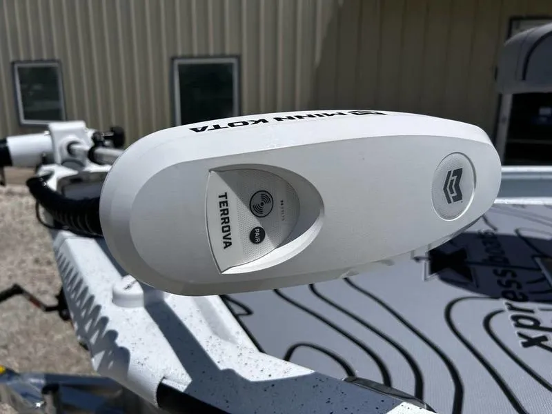 Slide: The Image of 2025 Xpress H22B boat with Minn Kota Terrova trolling motor, close-up view. - 11