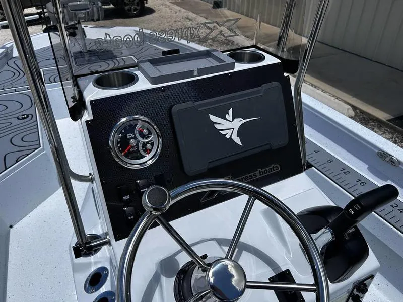 Slide: The Image of 2025 Xpress H22B boat dashboard with steering wheel and control panel. - 13