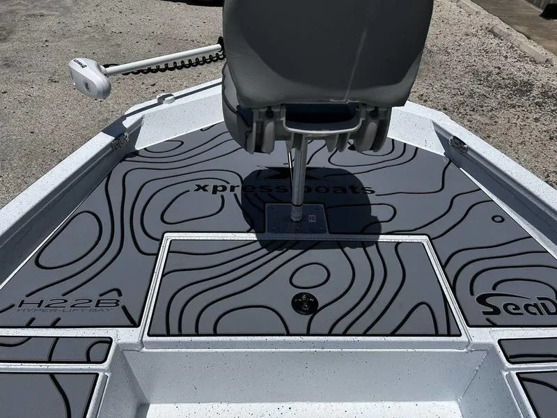 Slide: The Image of 2025 Xpress H22B boat deck with stylish black contour design and seating. - 14