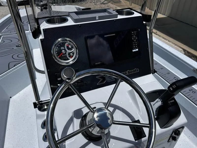 Slide: The Image of 2025 Xpress H22B boat dashboard with steering wheel and control panel. - 16
