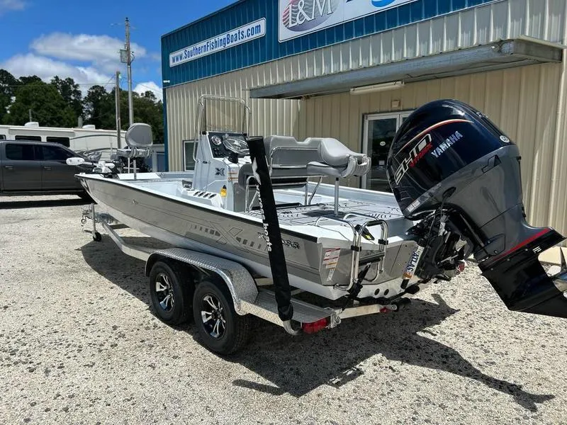 Slide: The Image of 2025 Xpress H22B boat with Yamaha engine, parked outside a dealership. - 3