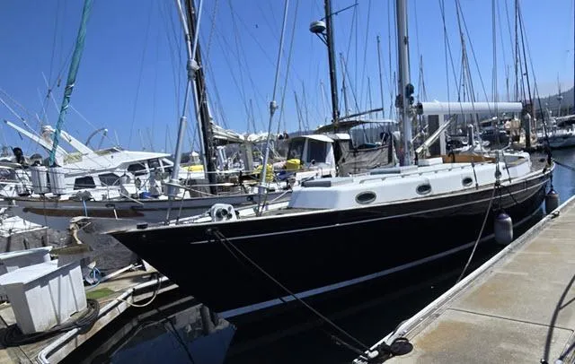 Slide: The Image of 1978 Formosa 46 sailboat docked in a marina under clear blue skies. - 1